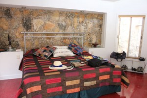 King size bed with rock back wall